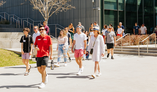 Tour guide with families showing them around campus